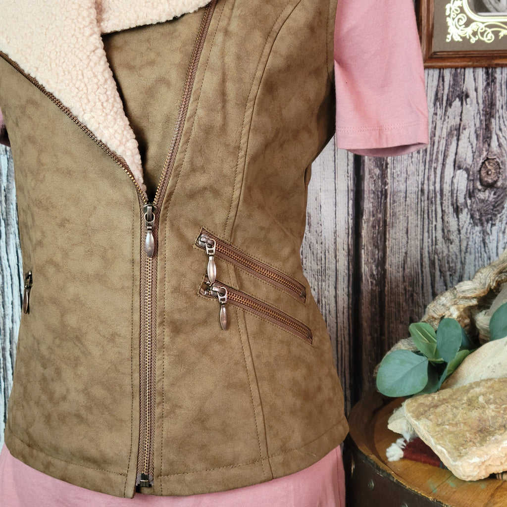 Brown vest with beige fleece interior and collar, featuring multiple front pockets.