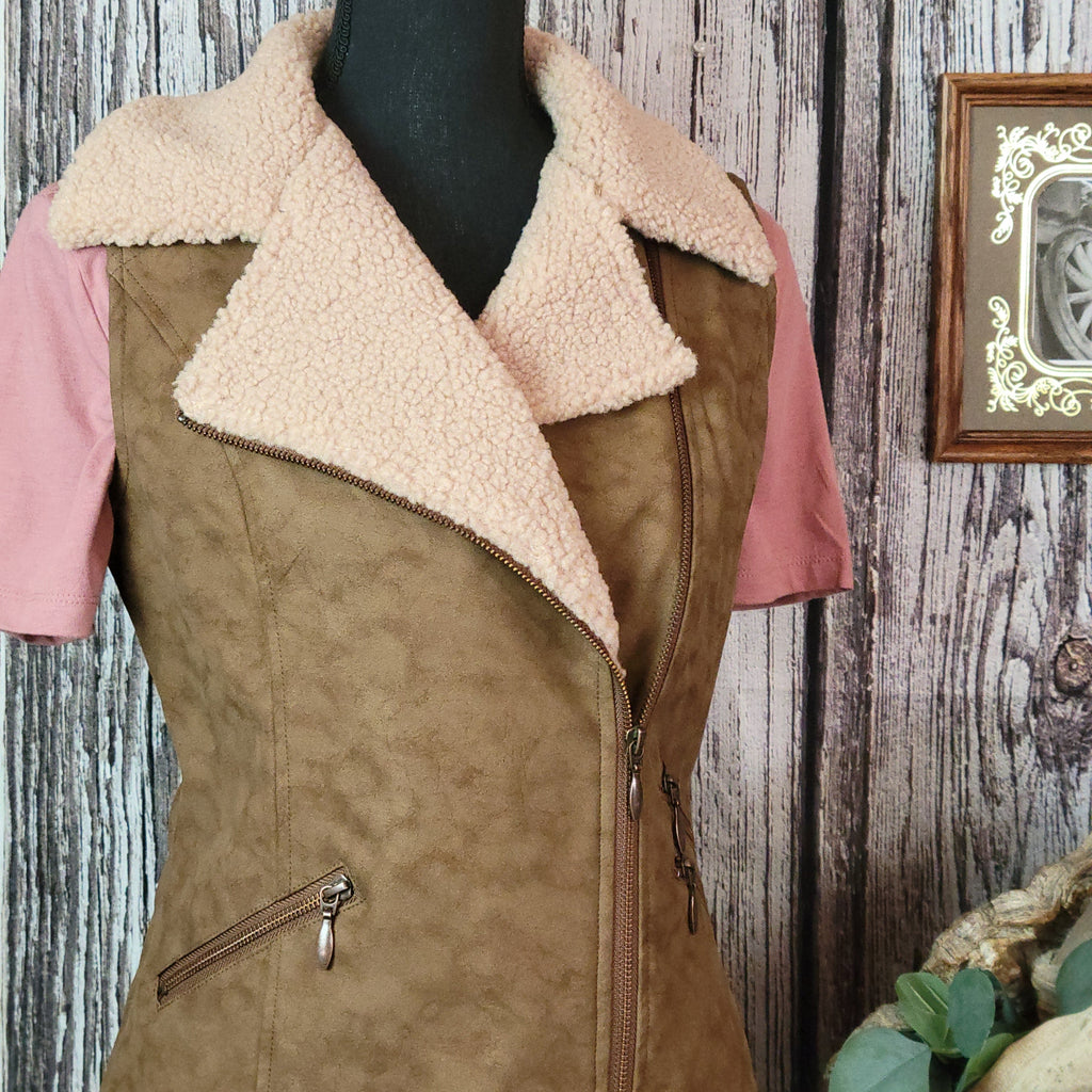 Brown vest with beige fleece interior and collar, featuring multiple front pockets.