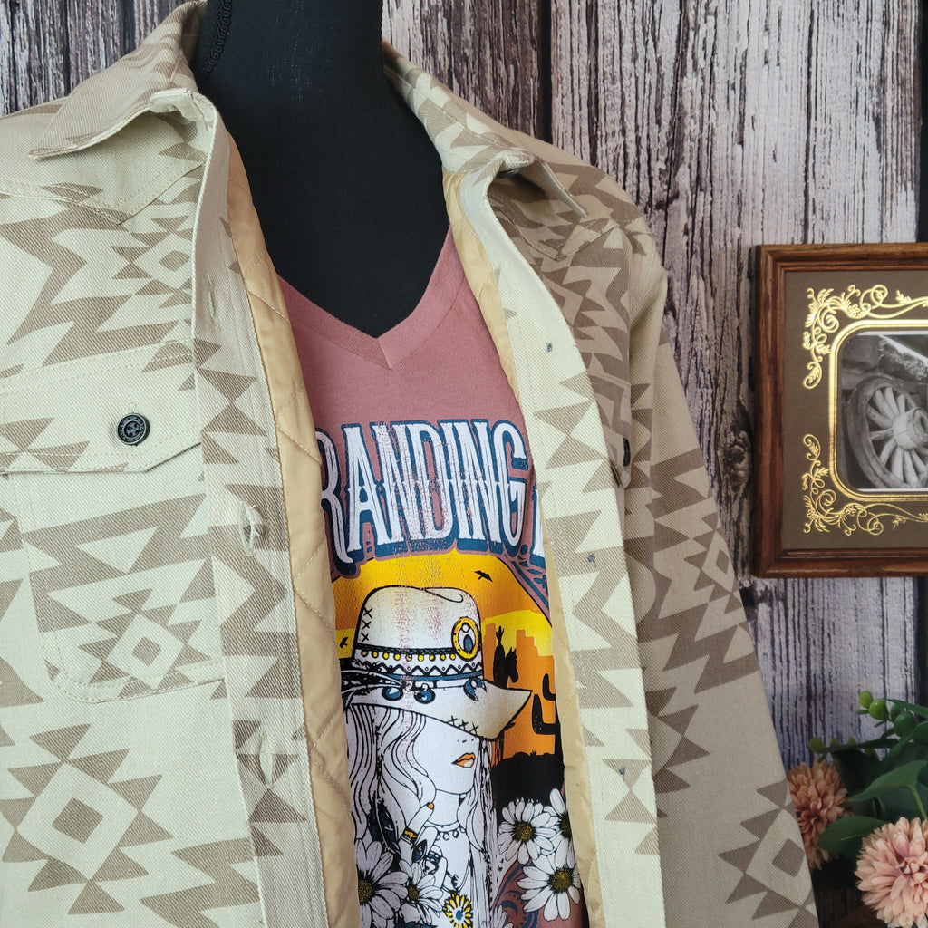 Cream colored shirt jacket with insulted interior and tan southwestern print.