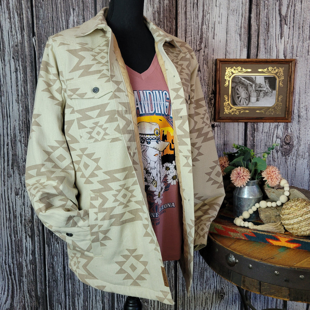 Cream colored shirt jacket with insulted interior and tan southwestern print.