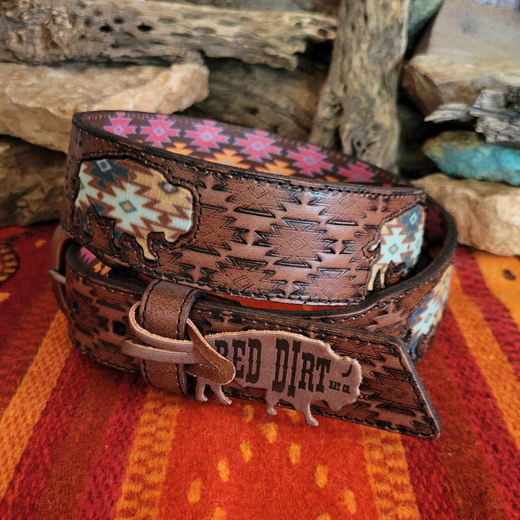 A rich brown leather belt with intricate tooled patterns and Aztec buffalo inlay.