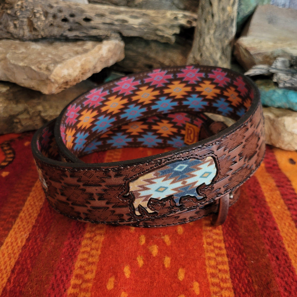 A rich brown leather belt with intricate tooled patterns and Aztec buffalo inlay.