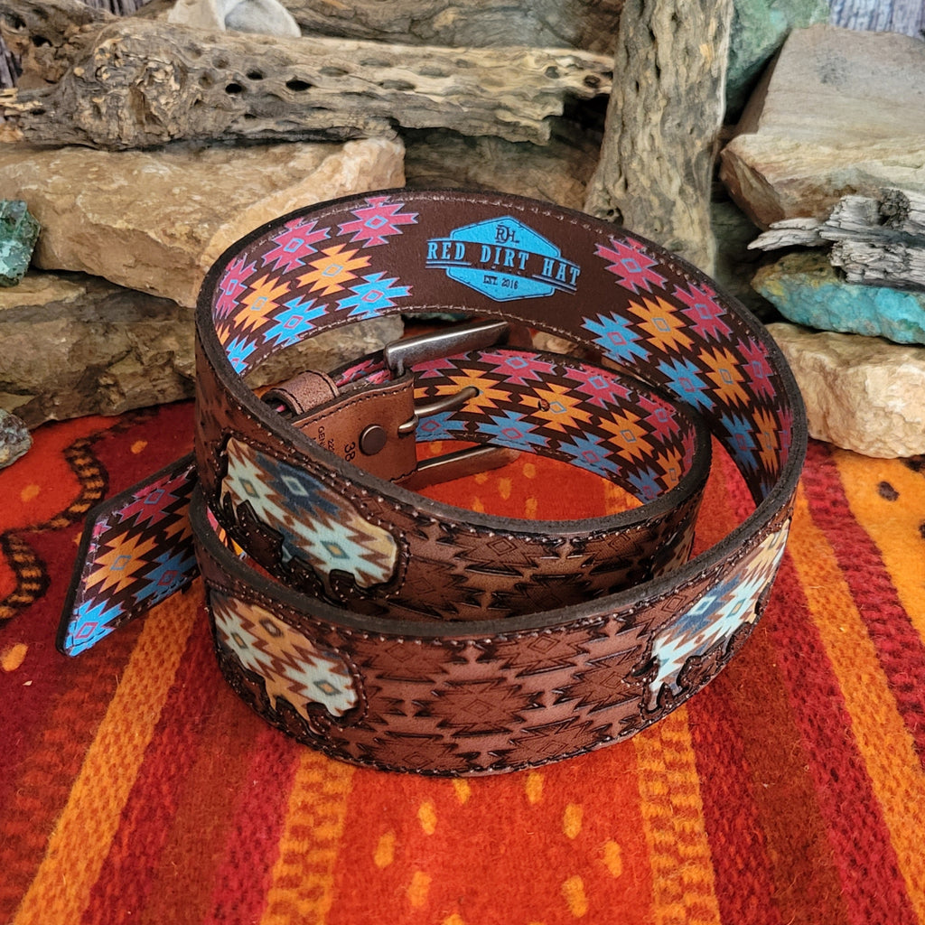 A rich brown leather belt with intricate tooled patterns and Aztec buffalo inlay.