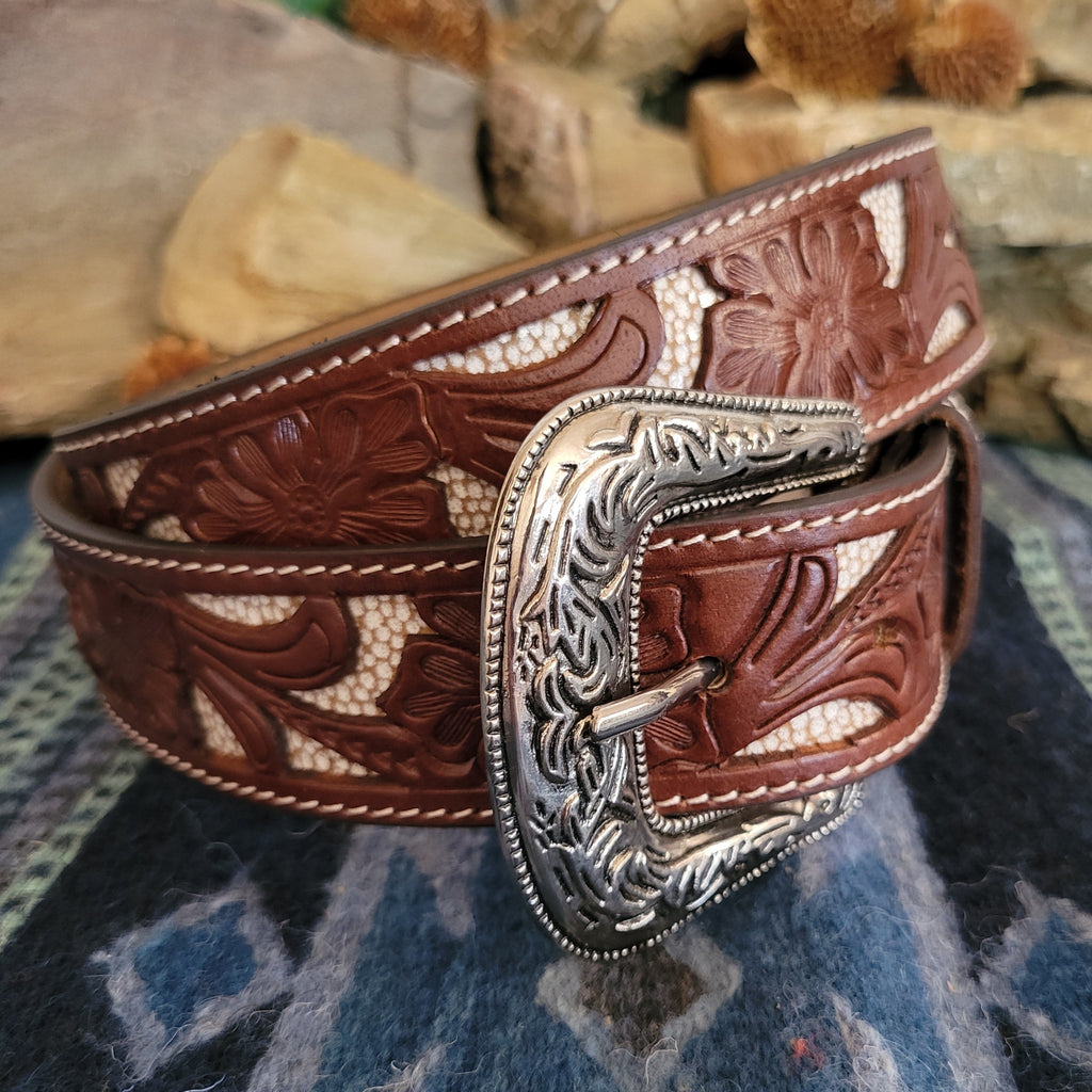 Silver-toned buckle with intricate scrollwork, paired with a sturdy brown leather strap.