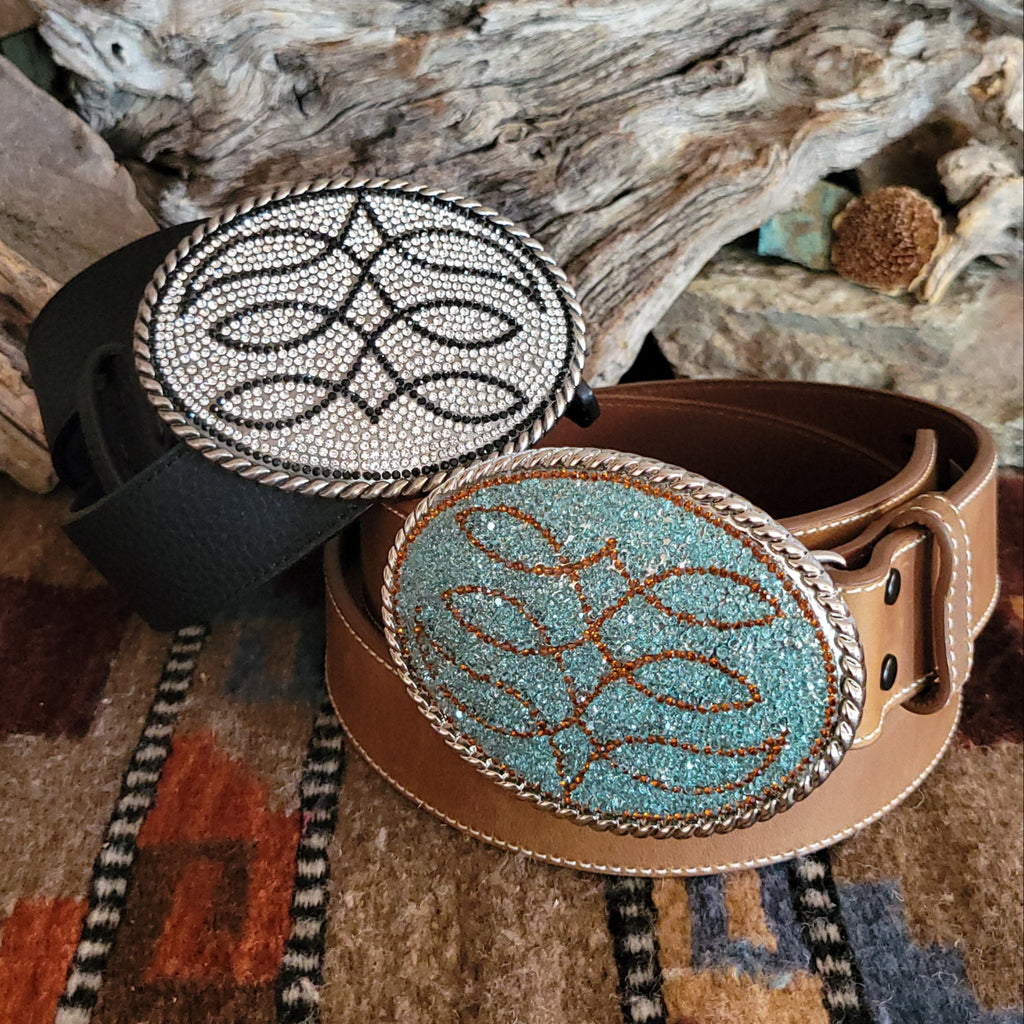 Two leather belts in the colors brown and black with decorative rhinestone buckles.