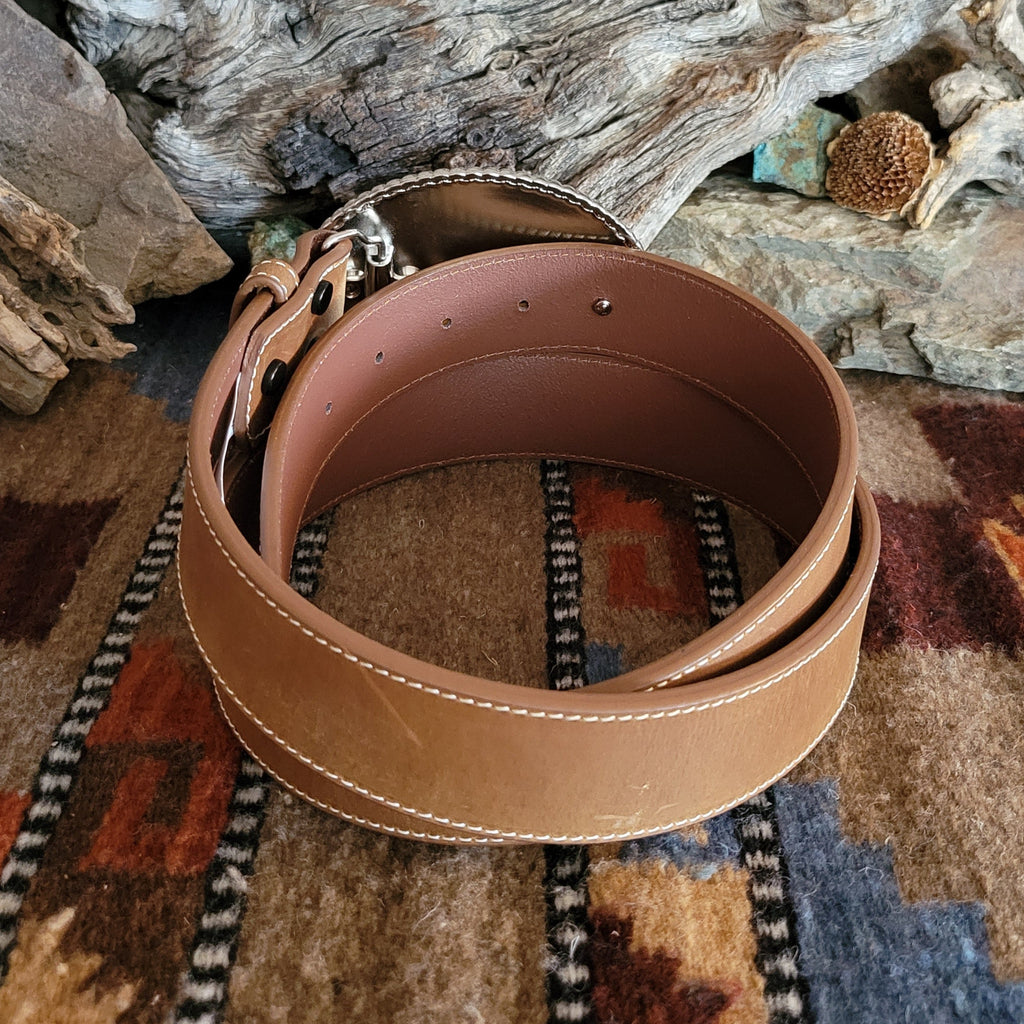 Smooth, brown leather belt with rhinestone buckle.