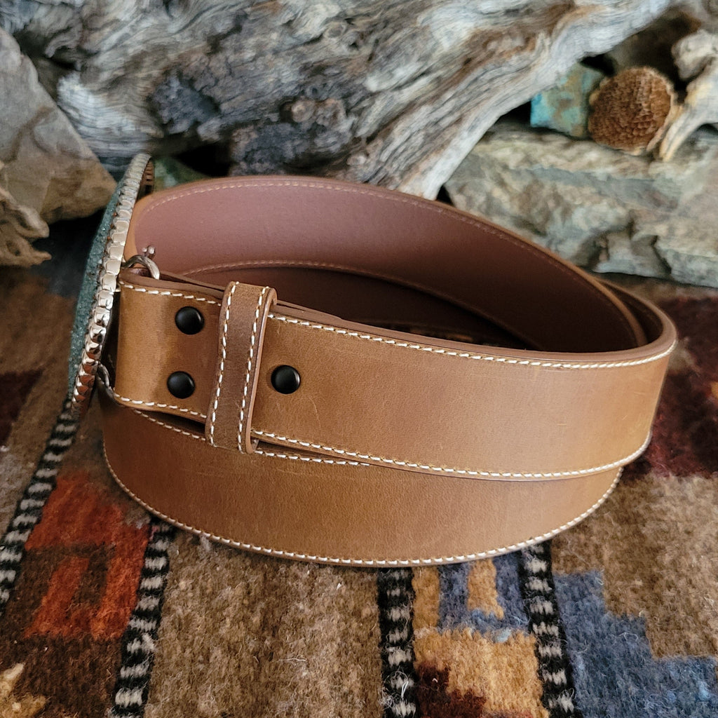 Smooth, brown leather belt with rhinestone buckle.