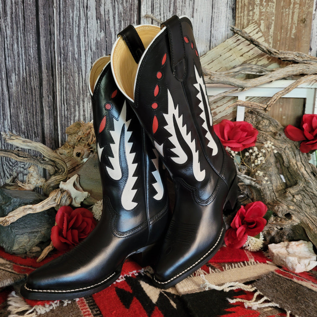 Black leather boot with snip toe and decorative white and red cut-out details on the shaft.