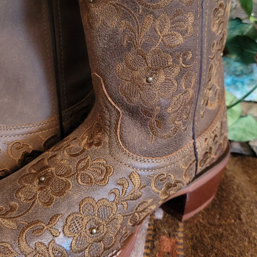 Close-up of the stitched floral details on the toe and shaft of the boot.