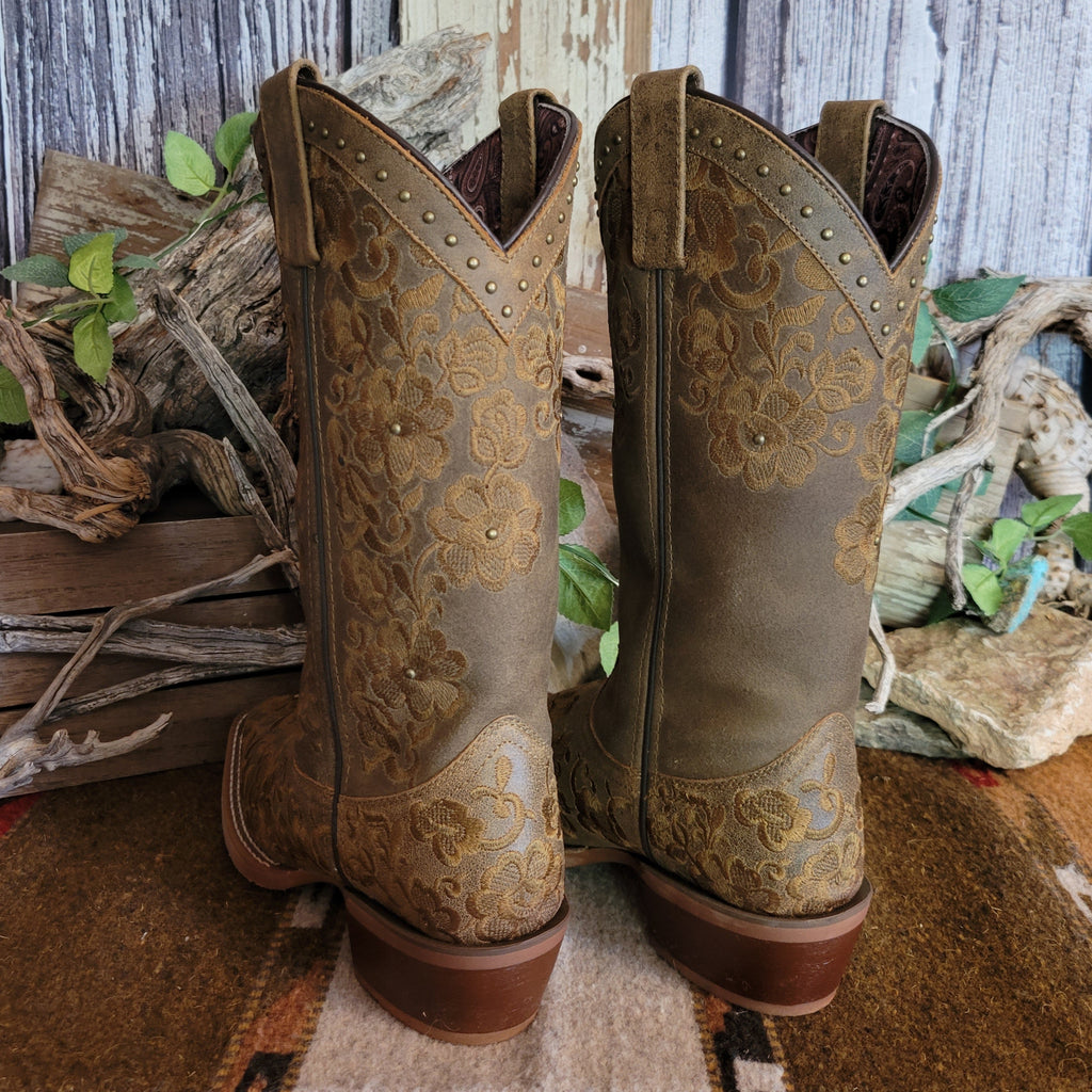 Brown leather boots with intricate floral stitching and decorative studs.