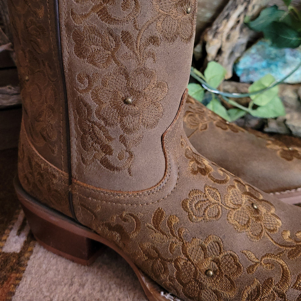Close-up of the stitched floral details on the toe and shaft of the boot.