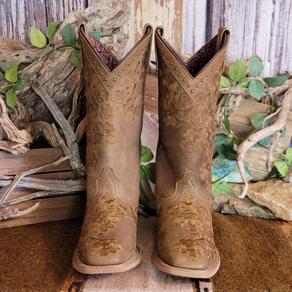 Brown leather boots with intricate floral stitching and decorative studs.