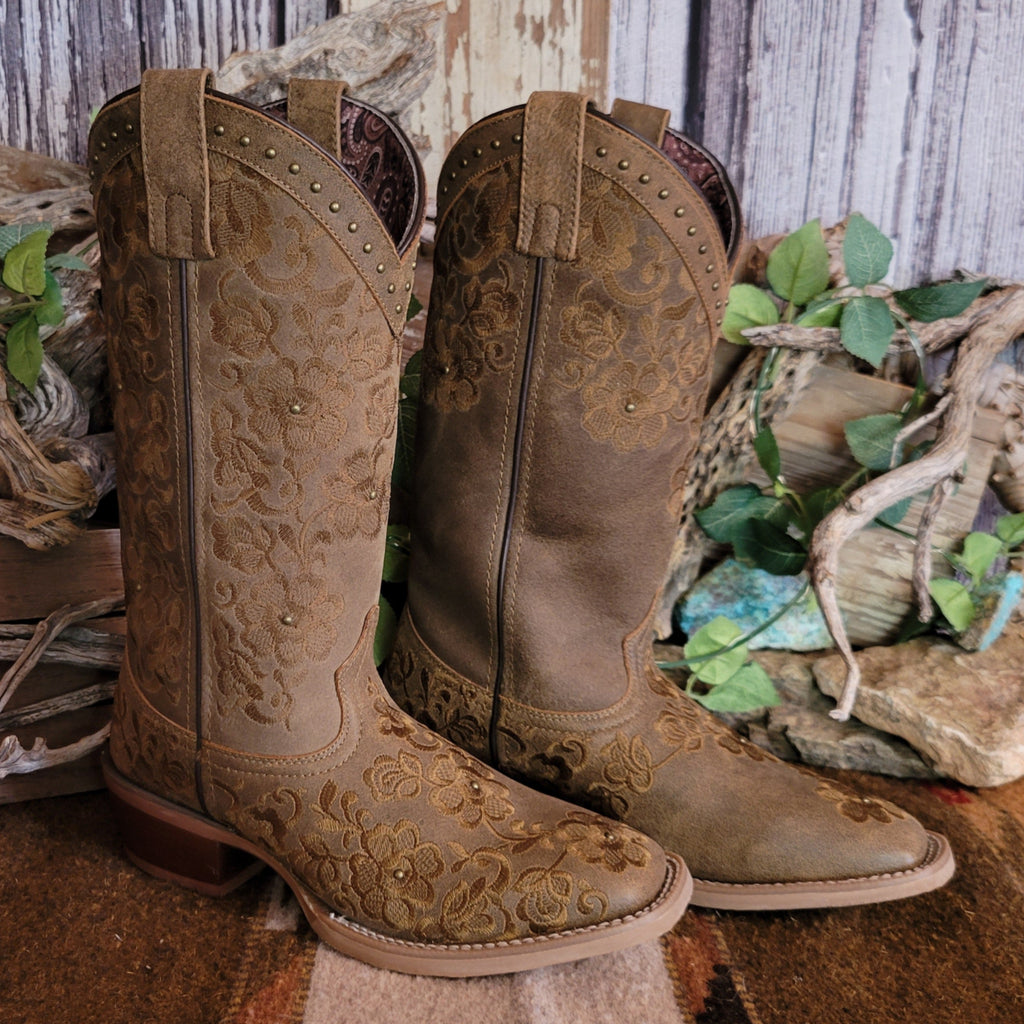 Brown leather boots with intricate floral stitching and decorative studs.