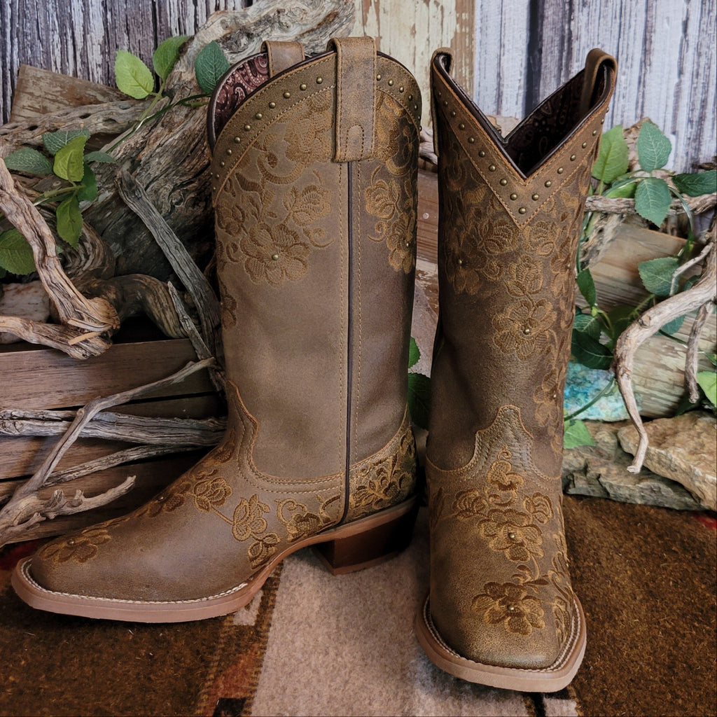 Brown leather boots with intricate floral stitching and decorative studs.
