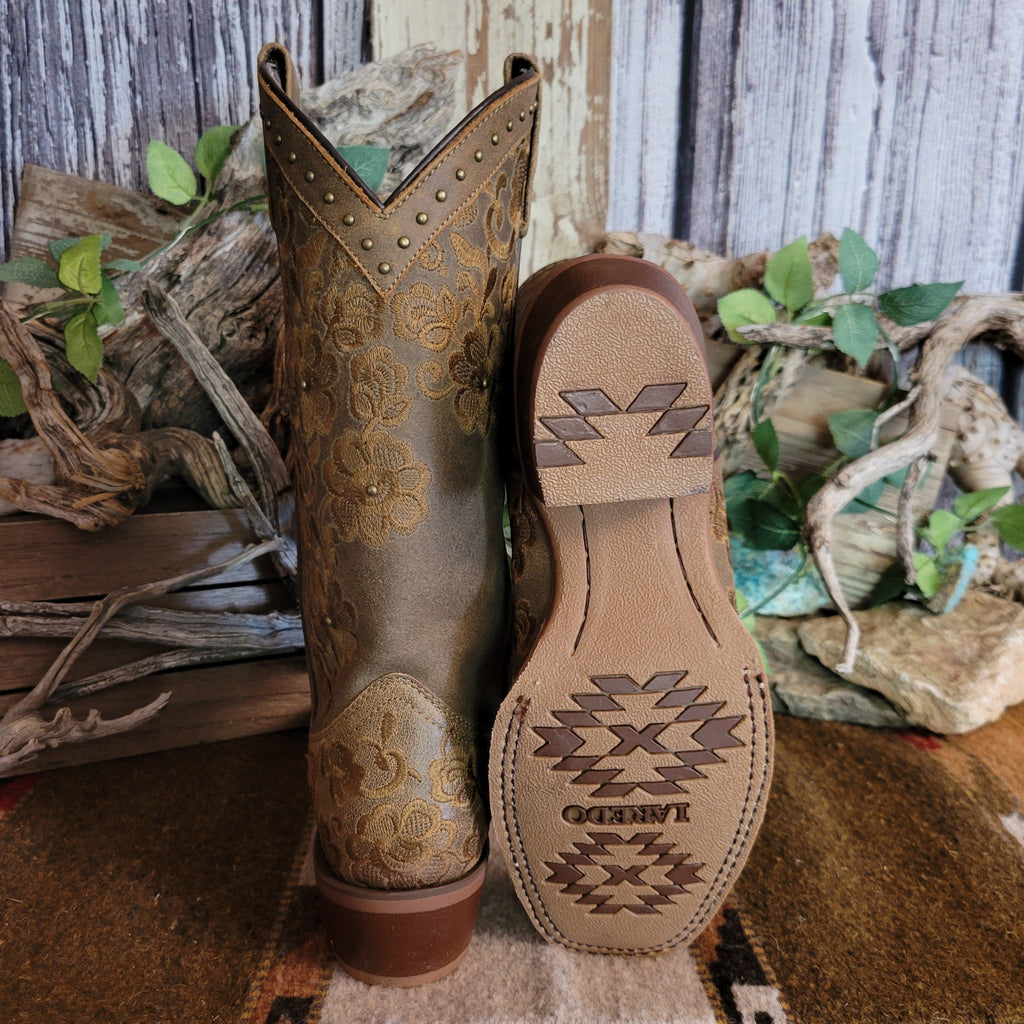 Brown leather boots with intricate floral stitching and decorative with leather and rubber sole.