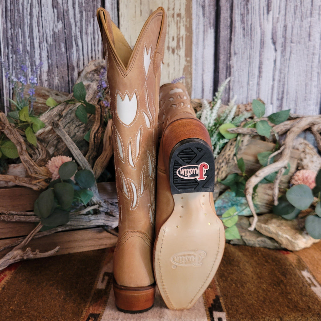 Tan leather boots with white floral cut-outs on the shaft and leather sole with rubber heel.