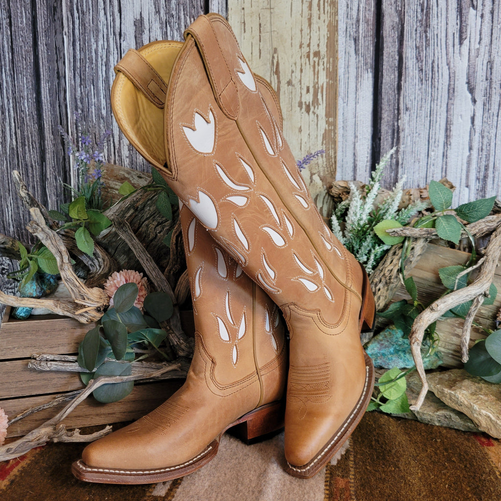 Tan leather snip toe boots with white floral cut-outs on the shaft.