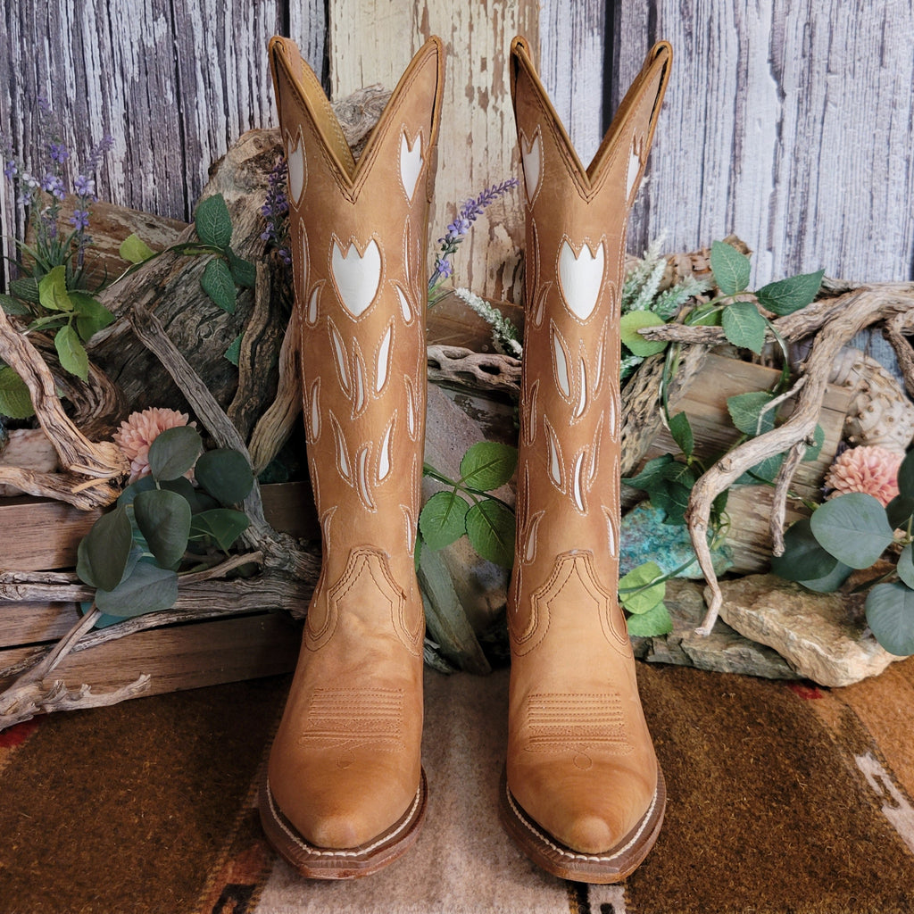 Tan leather snip toe boots with white floral cut-outs on the shaft.