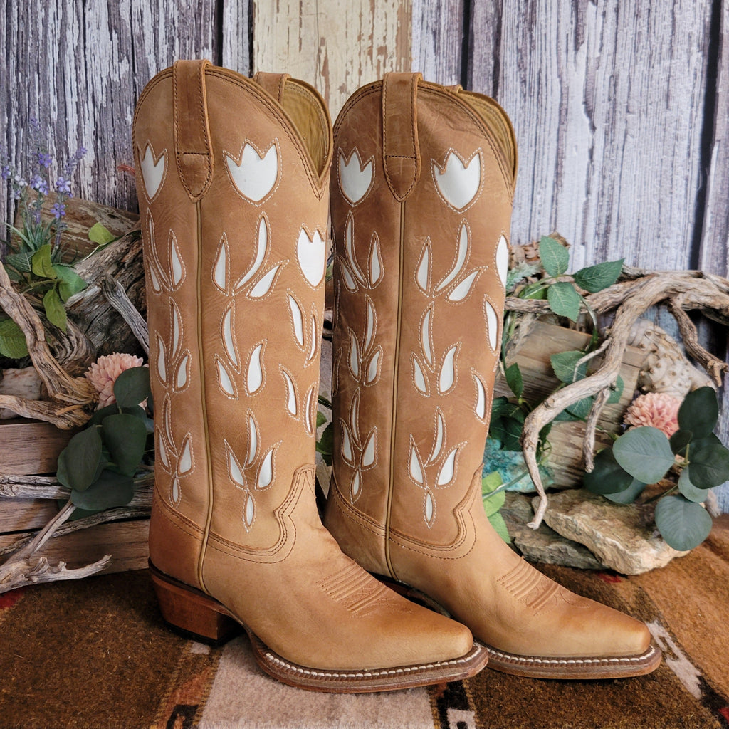 Tan leather snip toe boots with white floral cut-outs on the shaft.