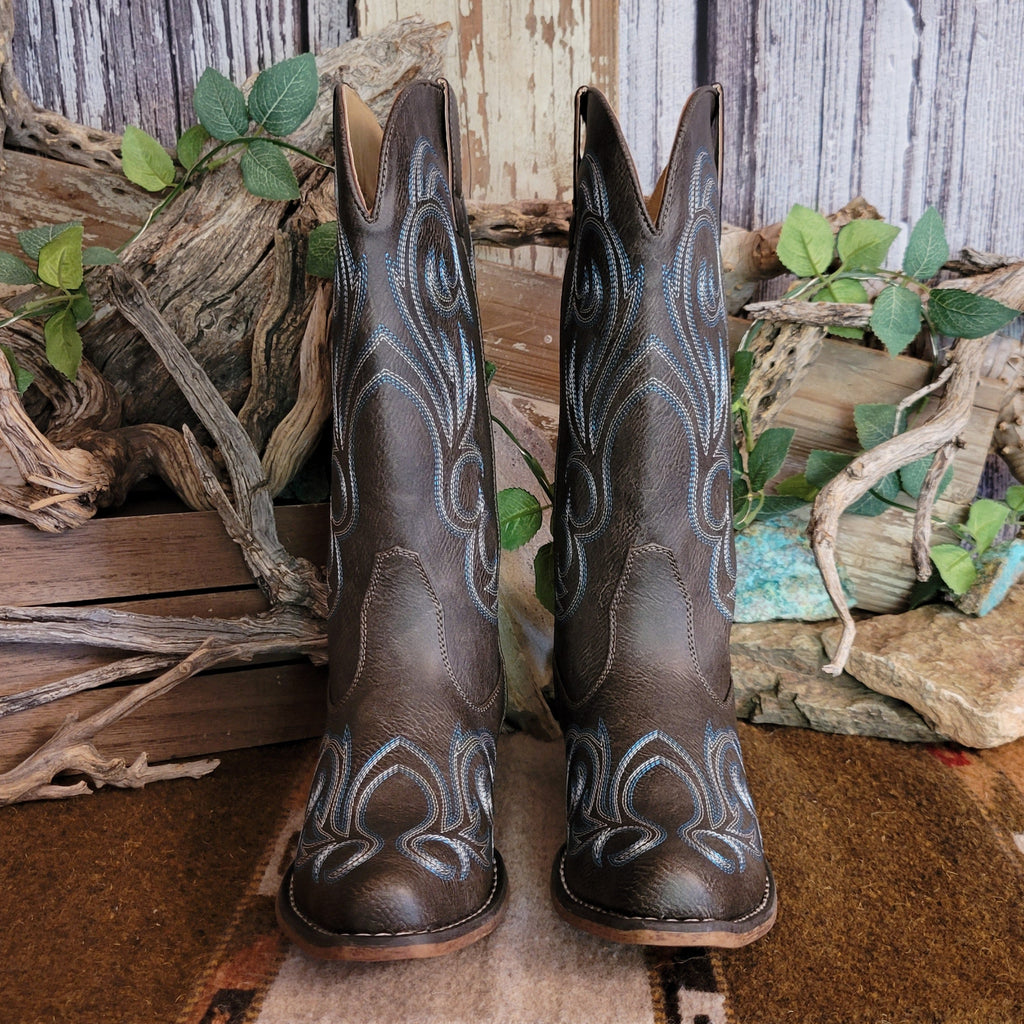 Dark brown faux leather snip toe boot with blue and white stitching along the shaft and toe.