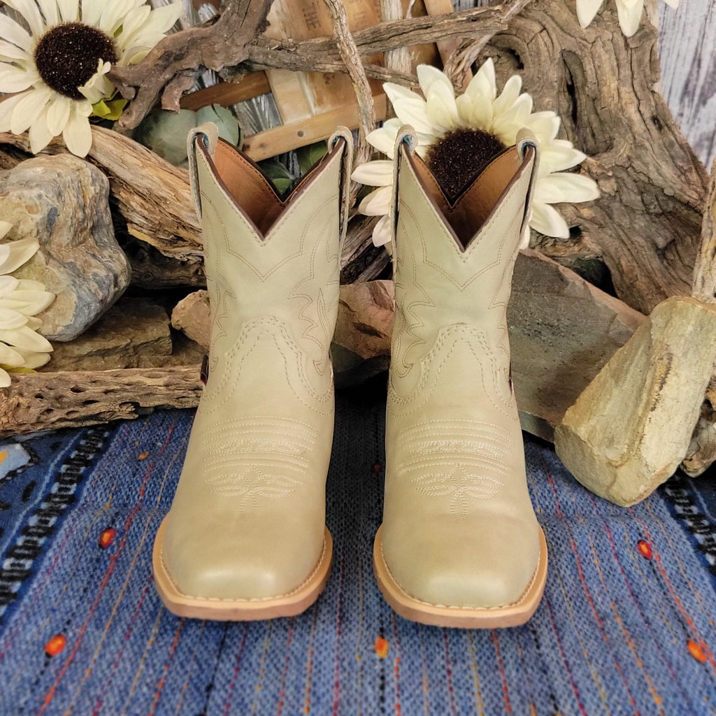 Pair of beige, leather ankle boots with western stitching.