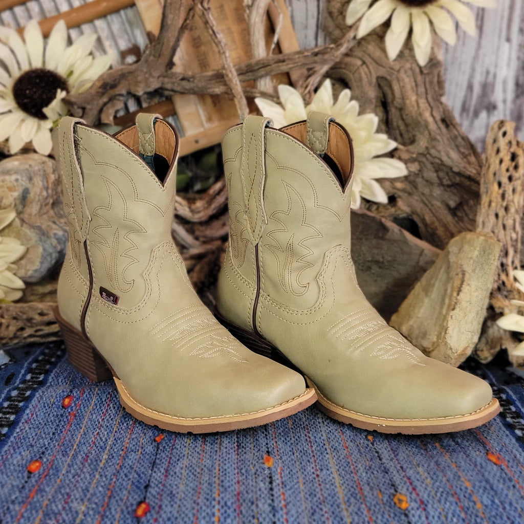 Pair of beige, leather ankle boots with western stitching.