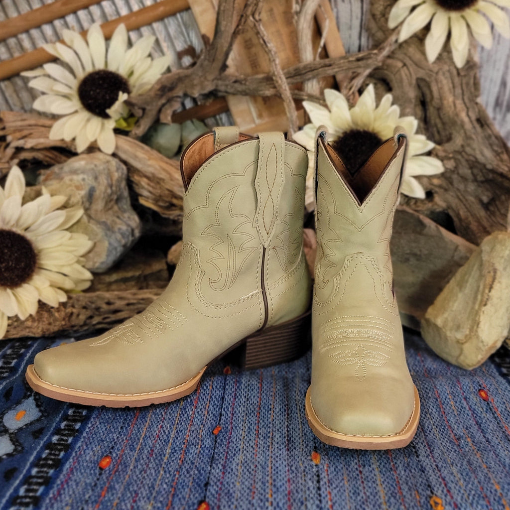 Pair of beige, leather ankle boots with western stitching.