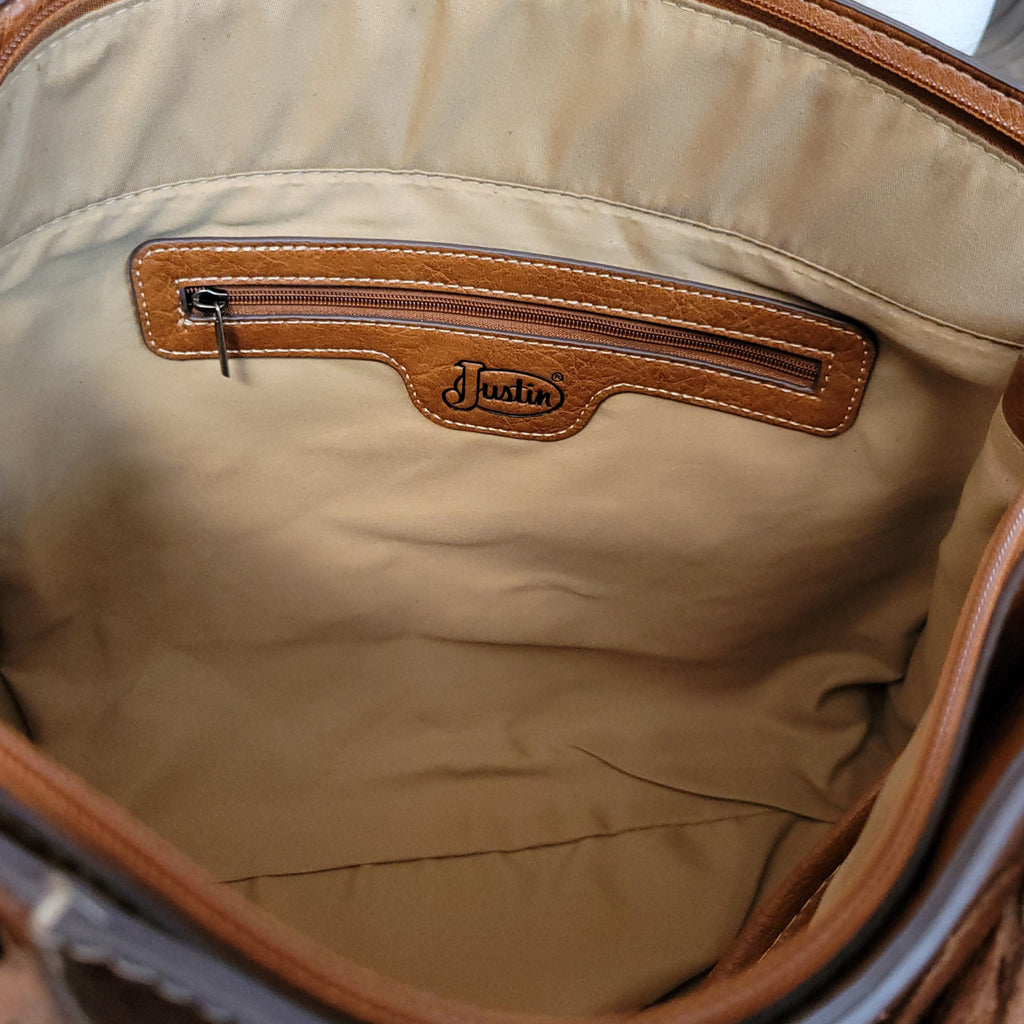 Inside of the tote featuring a zipper pocket and spacious room.