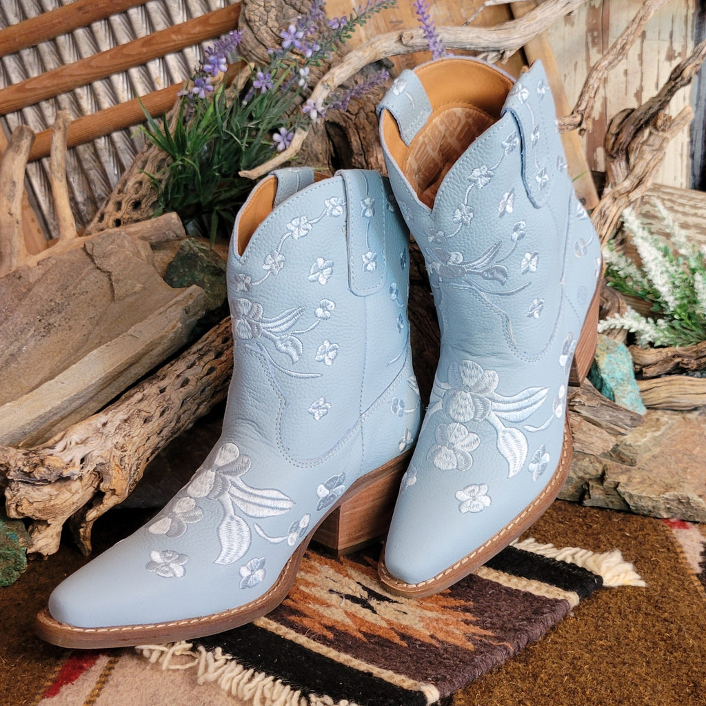 Blue ankle boots with a snip toe and floral embroidery.
