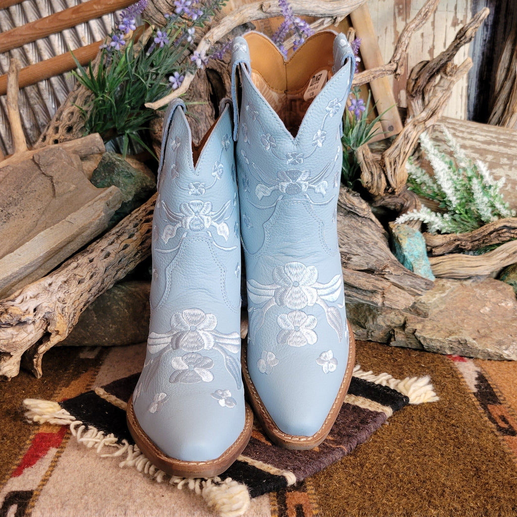 Blue ankle boots with a snip toe and floral embroidery.