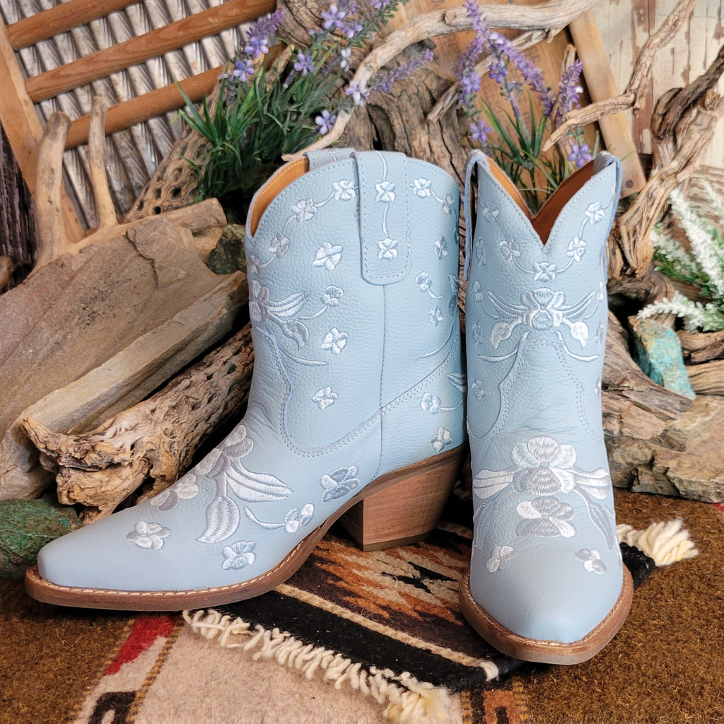 Blue ankle boots with a snip toe and floral embroidery.