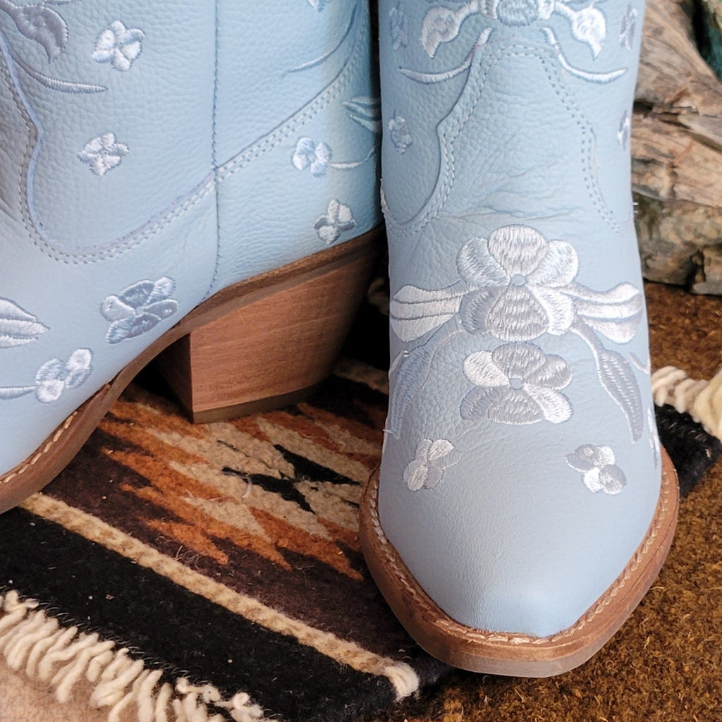 Close-up of the blue snip toe boot with floral embroidery.