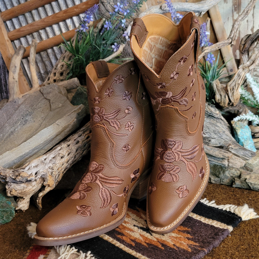 Brown ankle boots with a snip toe and floral embroidery.