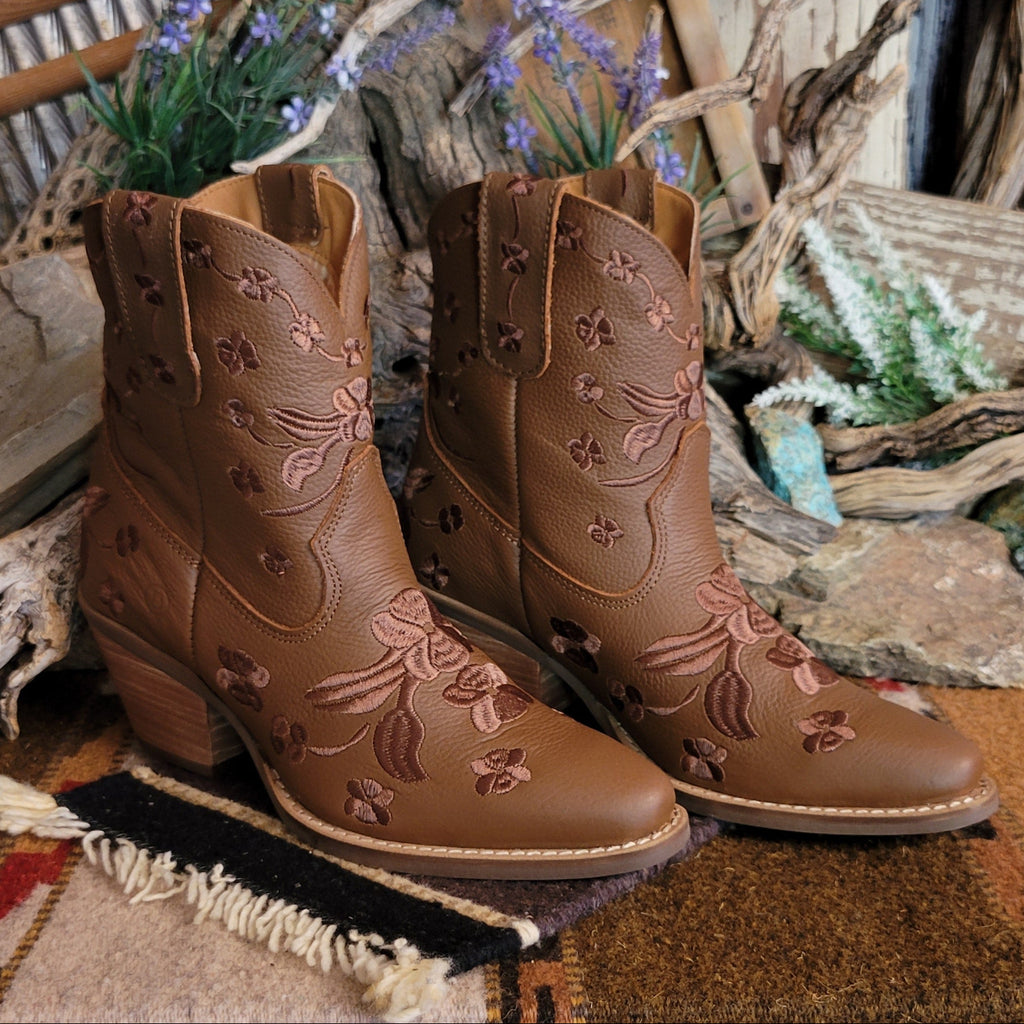 Brown ankle boots with a snip toe and floral embroidery.