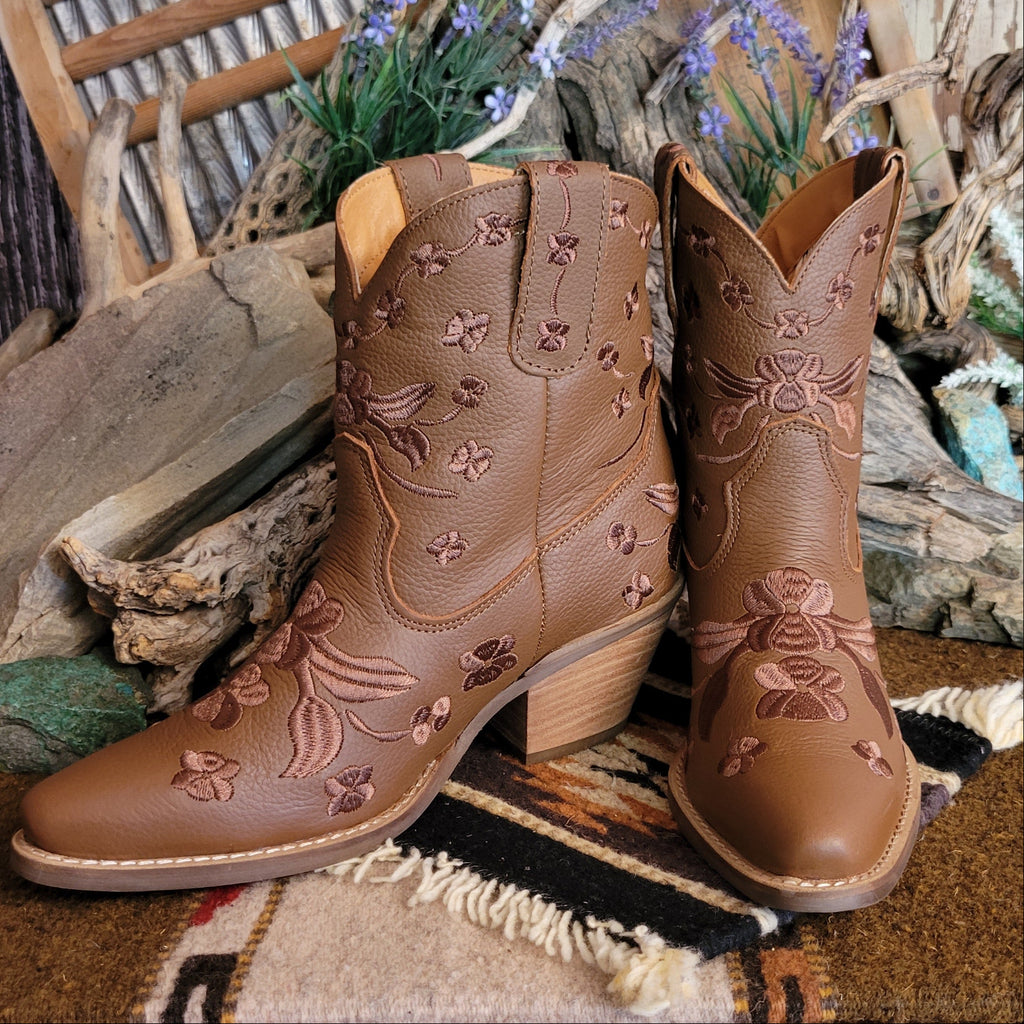 Brown ankle boots with a snip toe and floral embroidery.