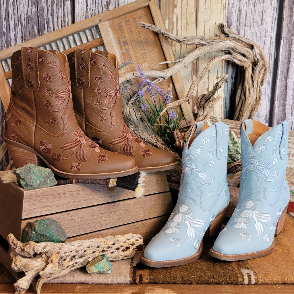 Pair of brown and light blue ankle boots with a snip toe and floral embroidery.