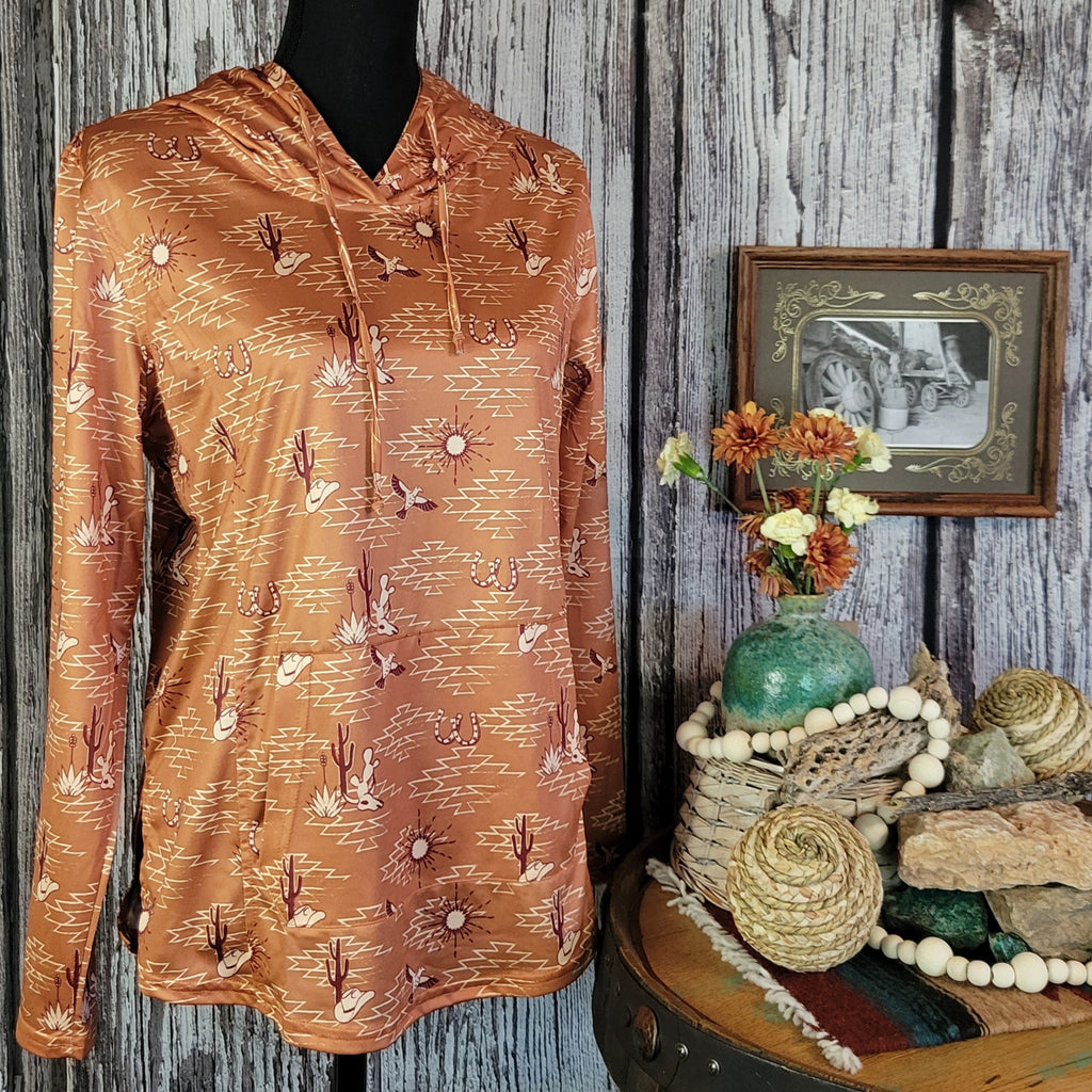 Performance hoodie in the color orange with a front pocket and western patterns.