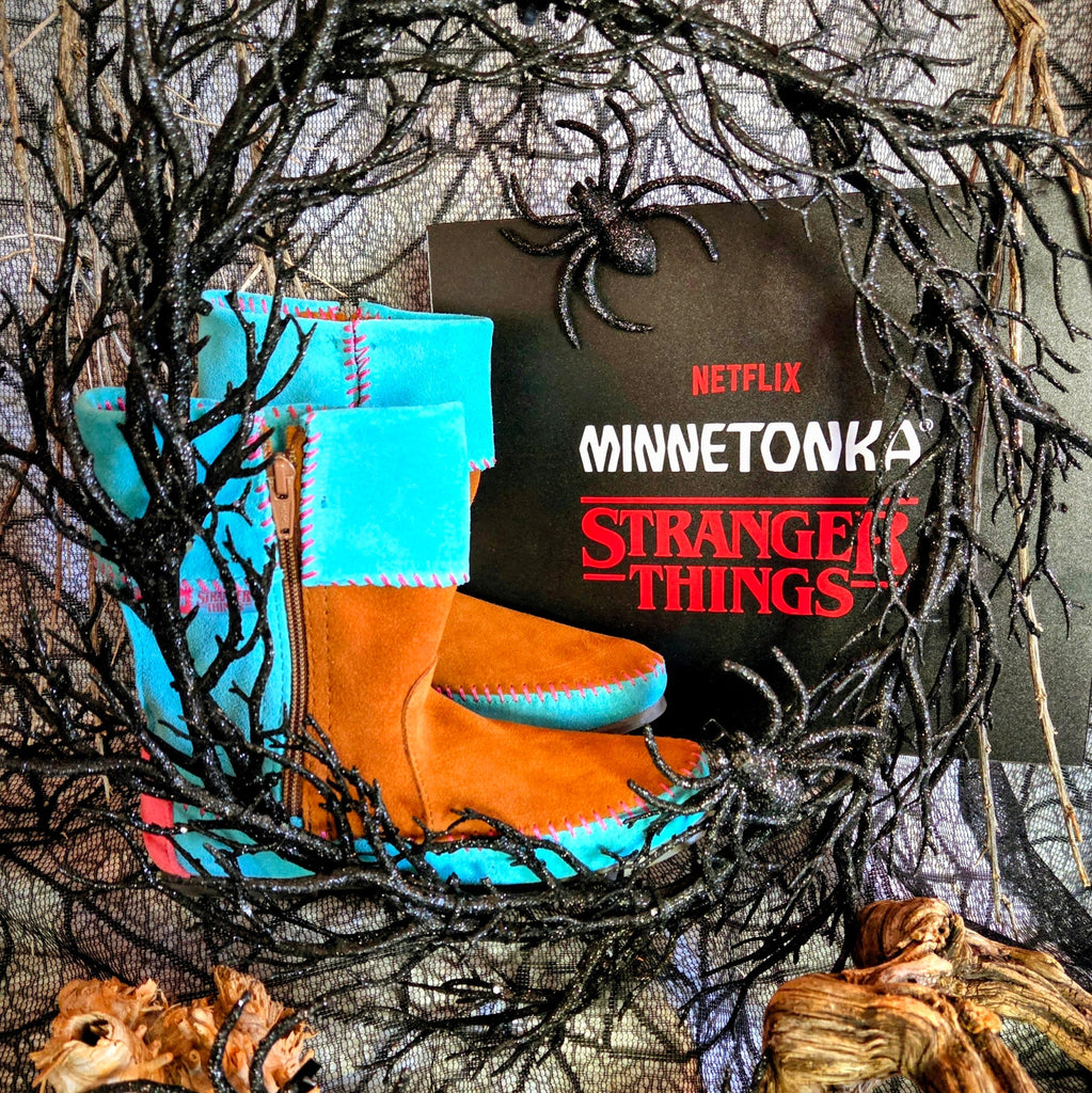 Women's Minnetonka Holly Wheeler Stranger Things moccasins in soft turquoise suede cuffs and tan fringe boots.
