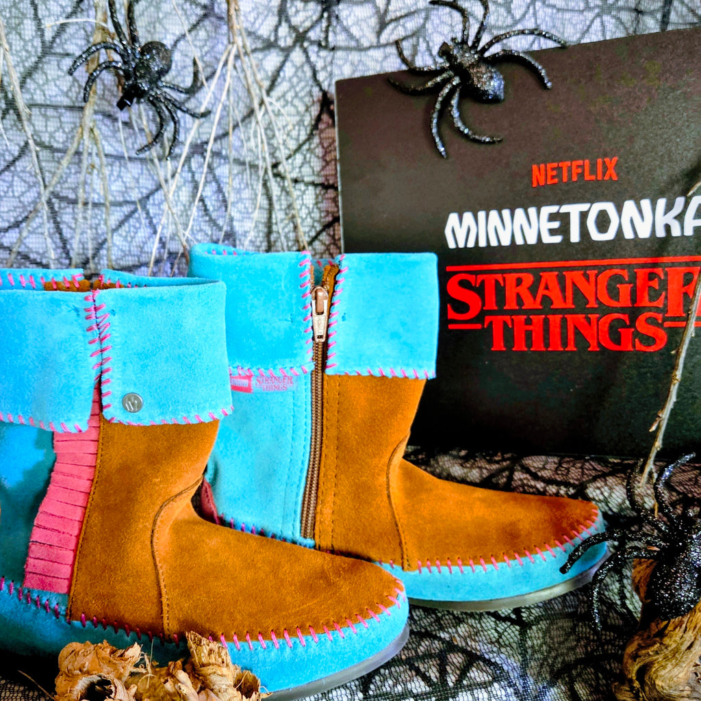 Women's Minnetonka Holly Wheeler Stranger Things moccasins in soft turquoise suede cuffs and tan fringe boots.
