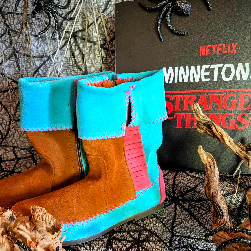 Women's Minnetonka Holly Wheeler Stranger Things moccasins in soft turquoise suede cuffs and tan fringe boots.