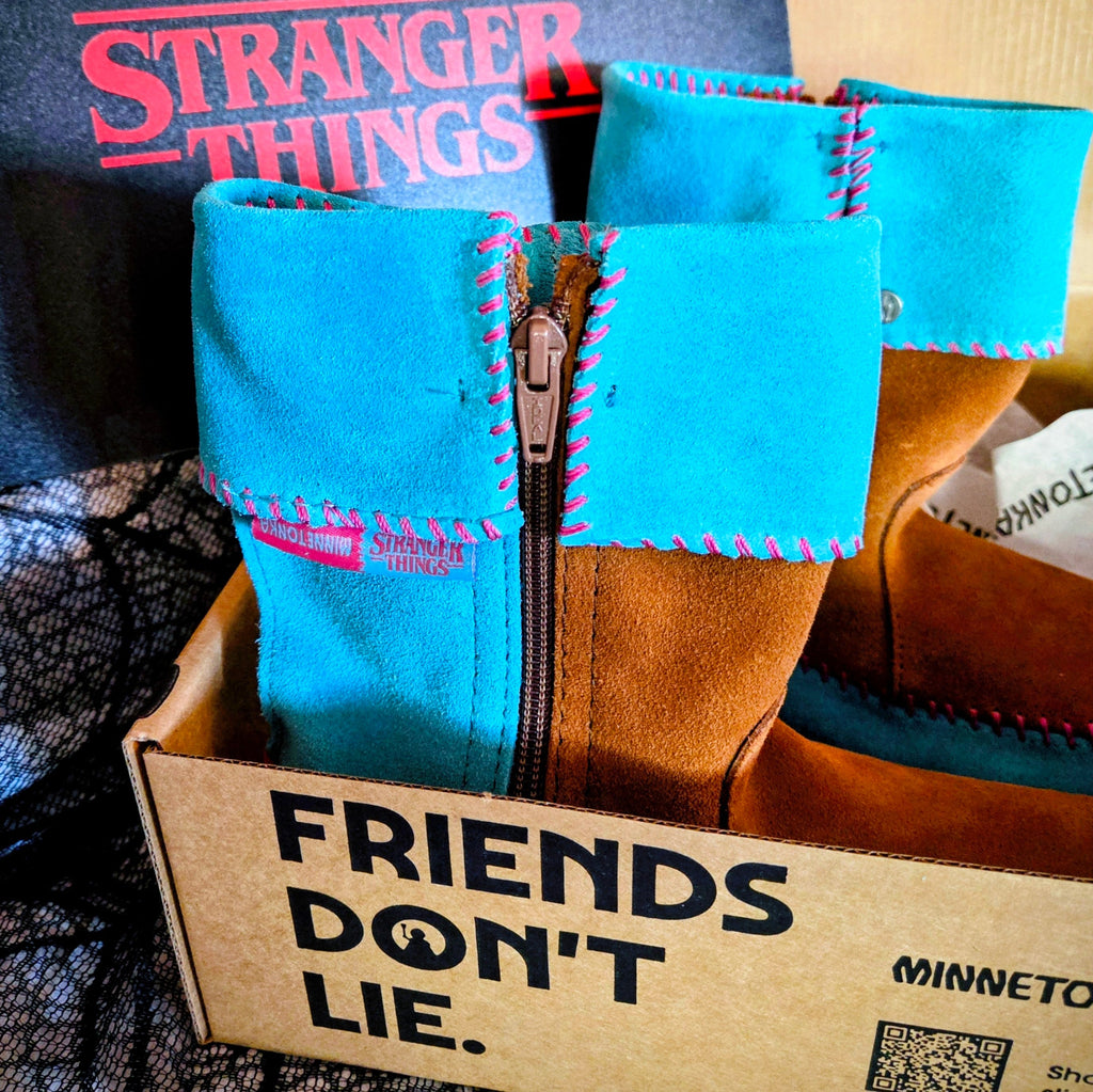 Women's Minnetonka Holly Wheeler Stranger Things moccasins in soft turquoise suede cuffs and tan fringe boots.