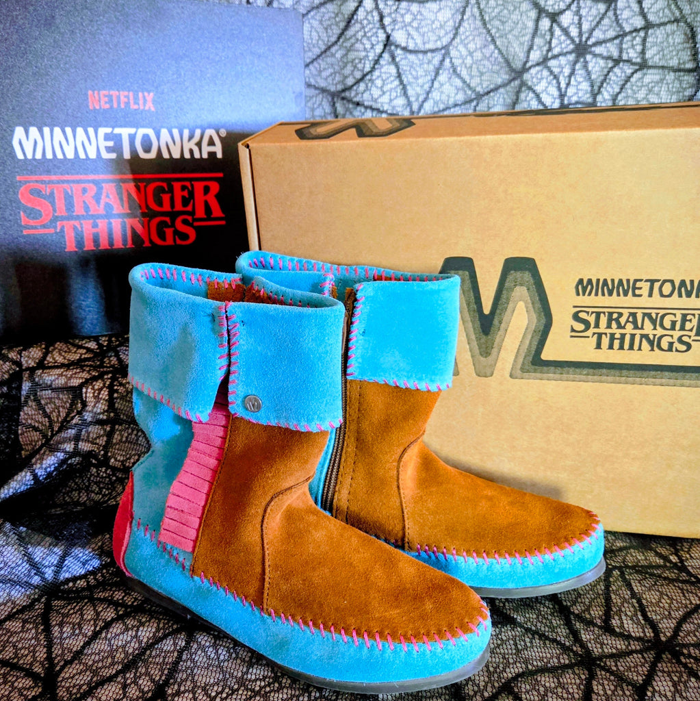 Women's Minnetonka Holly Wheeler Stranger Things moccasins in soft turquoise suede cuffs and tan fringe boots.