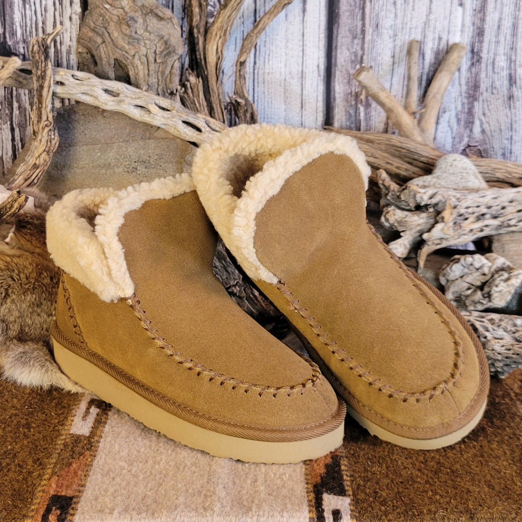Pair of tan moccasin boots with Berber lining and EVA outsole.