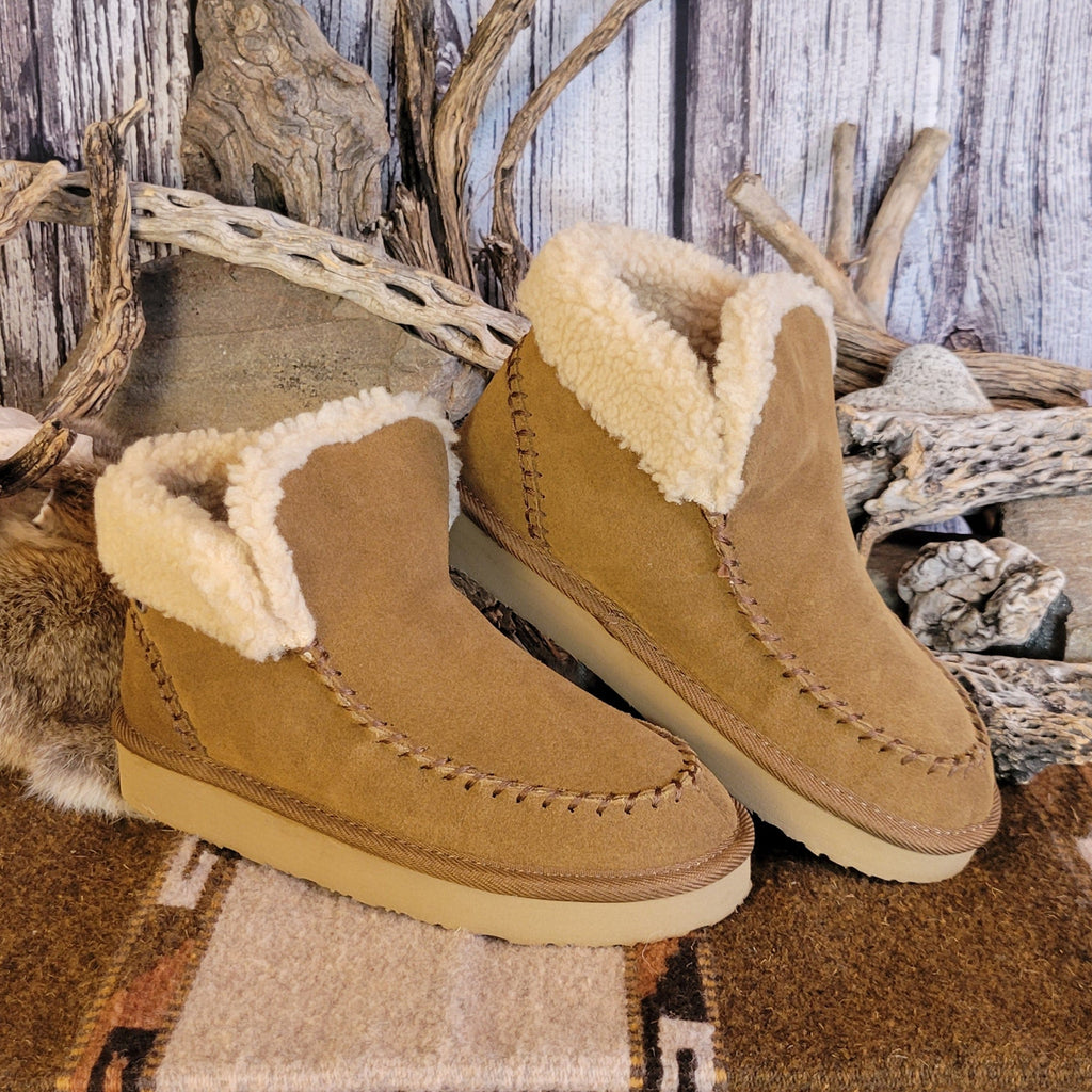 Pair of tan moccasin boots with Berber lining and EVA outsole.