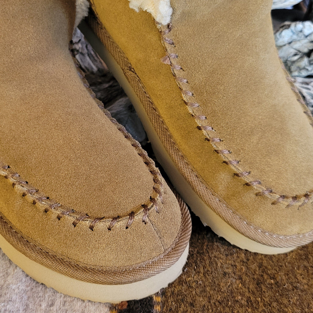 Pair of tan moccasin boots with Berber lining and EVA outsole.