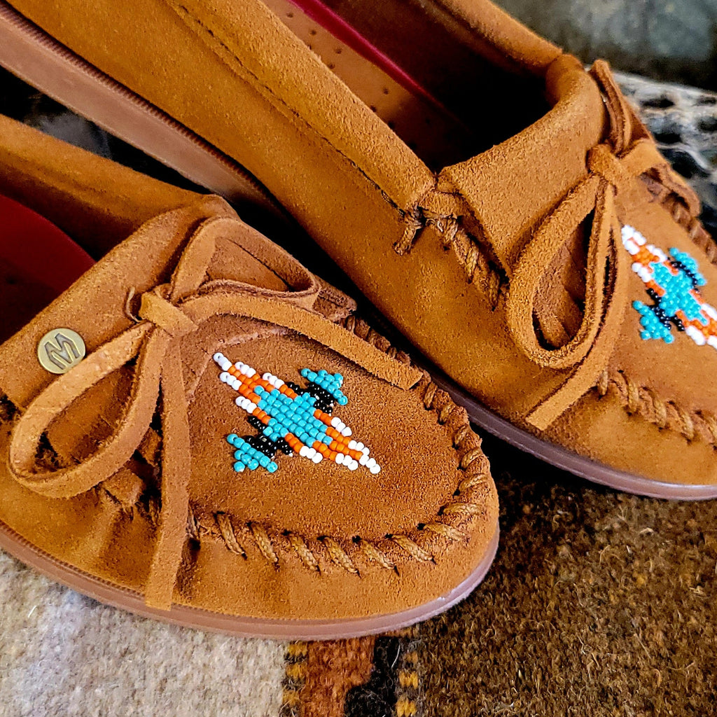 Close-up of the suede lace and beaded design on the toe.