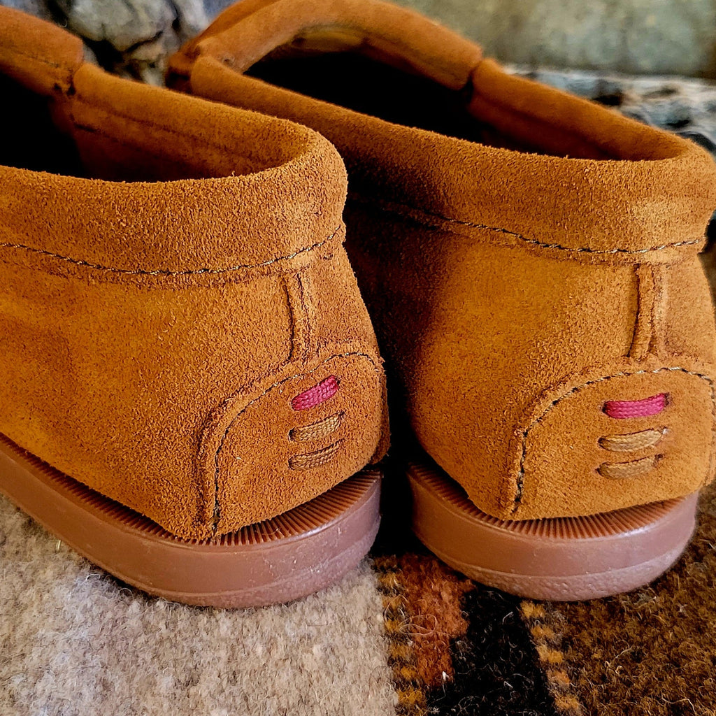 The back of the moccasins showcase the stitching.