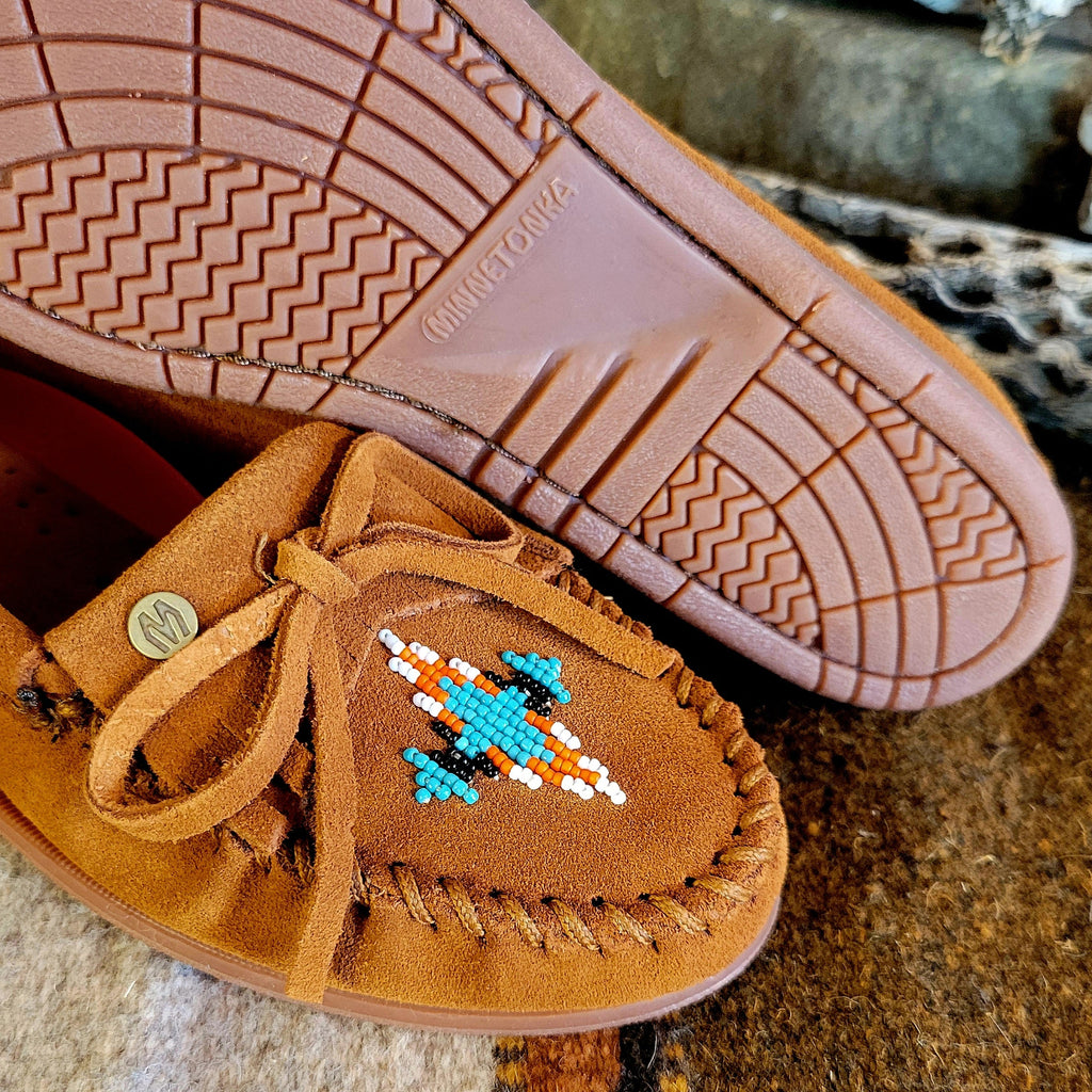 Close-up of the suede lace, beaded design on the toe, and rubber outsole.