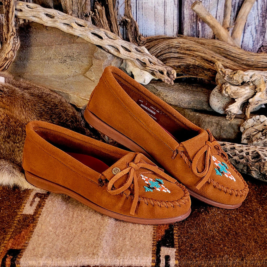 Pair of brown moccasins with decorative beading.