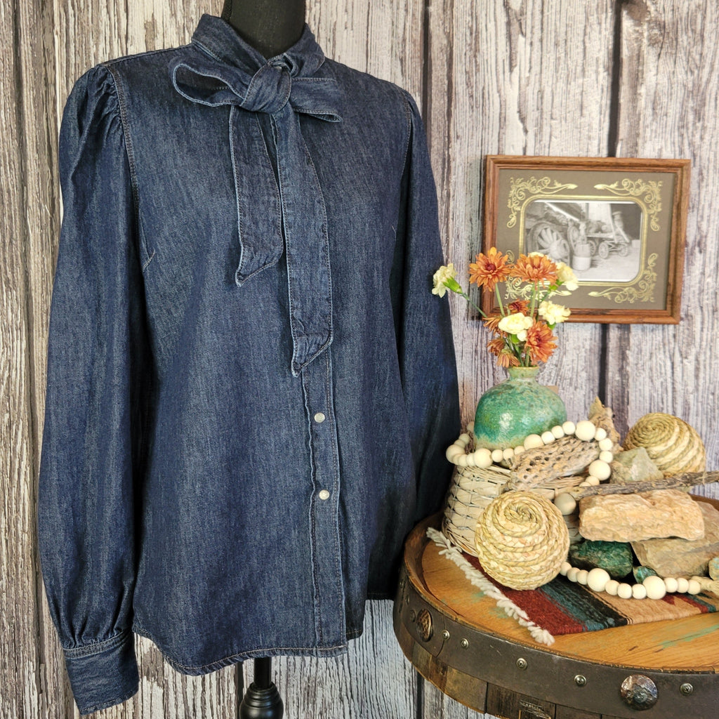 Denim shirt jacket with a denim tie on the collar and snap buttons.